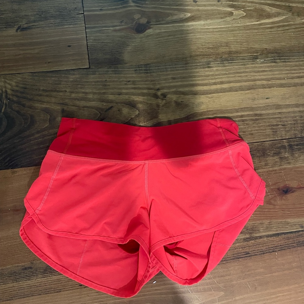 size 2 speed up 2.5 inseam, orange, worn but perfect condition